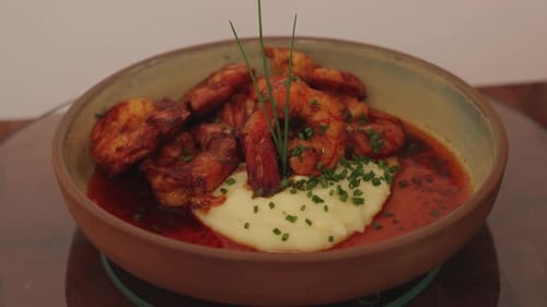 Delicious creamy mashed potato topped with lemon paprika shrimps, beautifully plated and garnish
