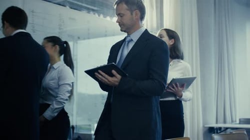 Businessman and his Secretary are Walking through Office.