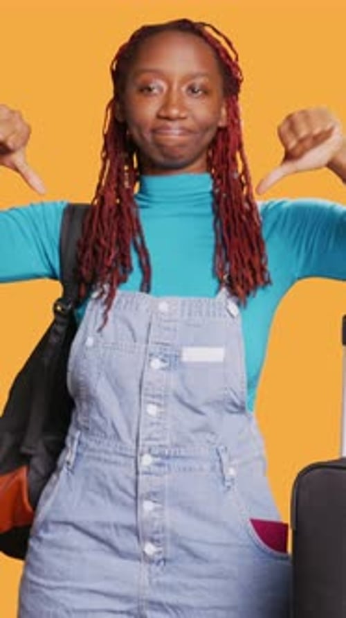 Young Adult Giving Thumbs Down with Suitcase