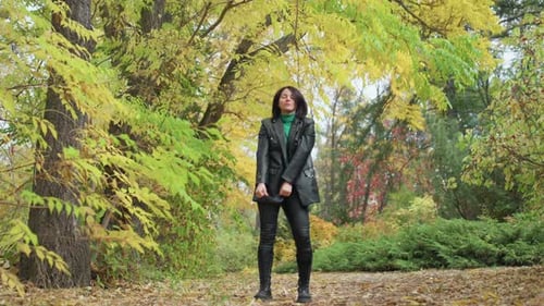 Woman Leather Jacket Walking Autumn Woods Green Scarf Confident Stride Among Yellow Leaves Soft