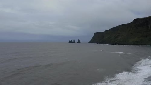 Drone panoramic shot of Reynisfjara black sand beach in the southern coast of Vik in Iceland