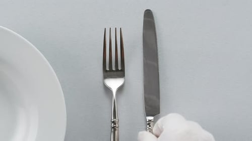 Table Setting of Fork and Knife Being Set