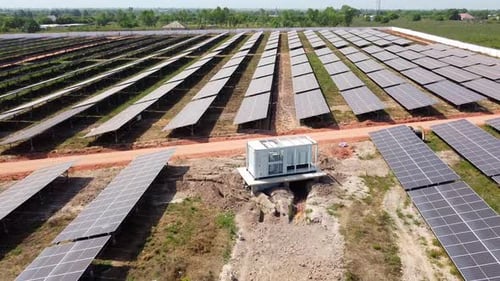 Solar PV farm industrial inverter module with visible DC combiner box cables during installation