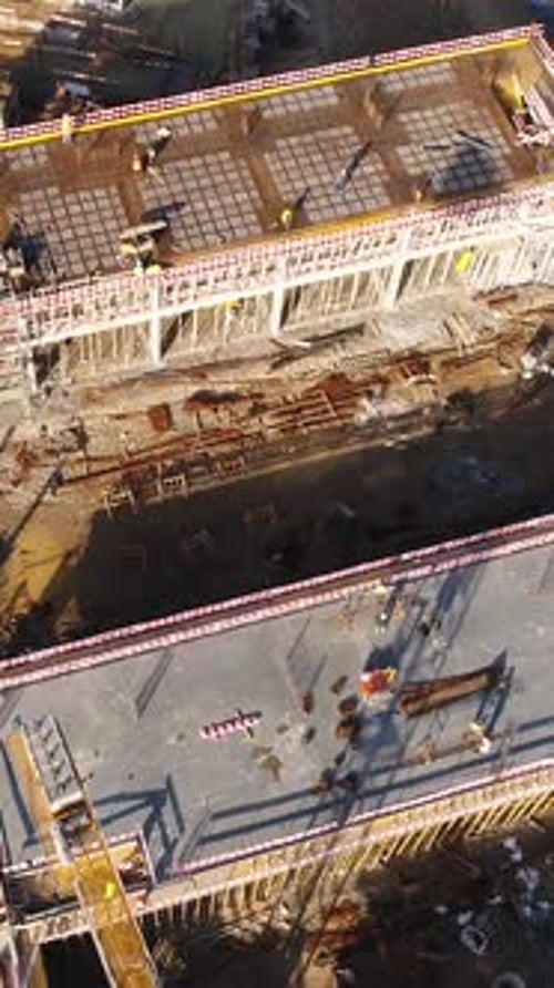 Vertical Video of Construction Workers in the Roof of New Building