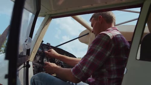 Serious Pilot Checking Control Panel Steering Wheel Modern White Airplane Before Flight