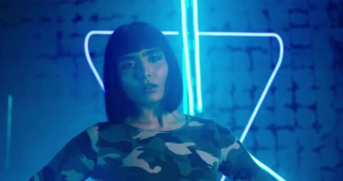 Skilled Lady in Trendy Green Long Sleeve Shirt Dances Techno