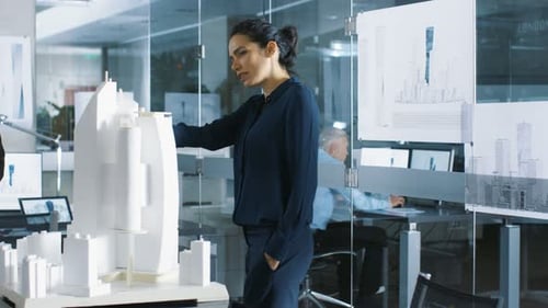 Two Young and Progressive Architectural Engineers Have Discussion about Building Model that is Par