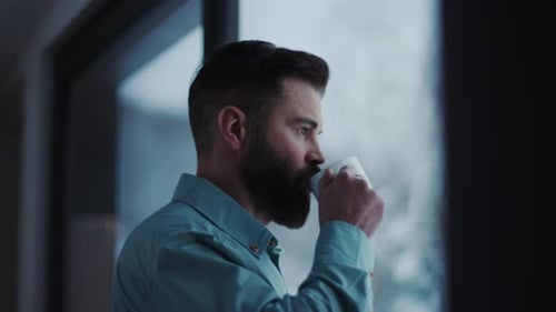 Close Up Handsome Businessman Drinking Coffee and Admire View Standing By Window in Office