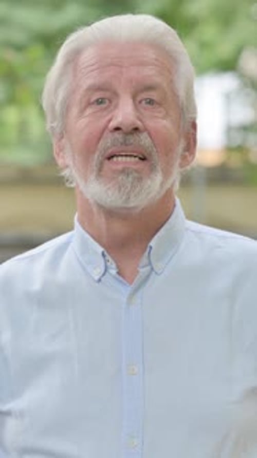 Senior Man Talking and Smiling in Outdoor Setting