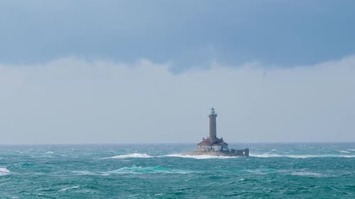 Lighthouse Porer under strong south wind and waves on stormy weather, restless sea