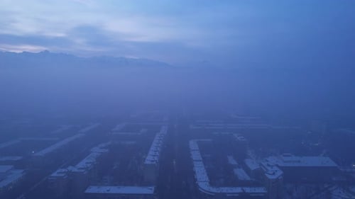 Dawn Over the City in Fog and Smog