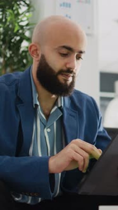 Adult Man Using Tablet Device in Office
