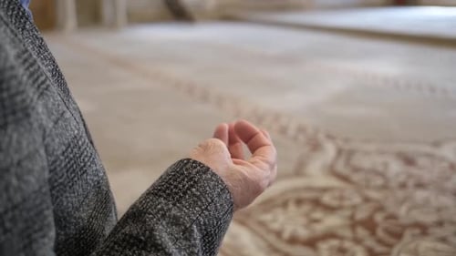 Senior Adult Hands Praying in Mosque