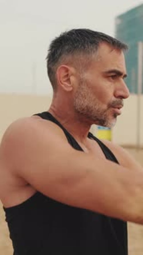 Man Stretching Arms on a Beach