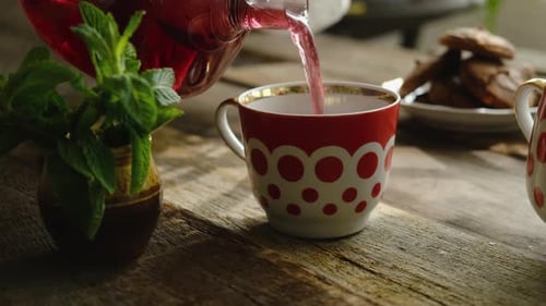 Tea Party Pouring Hot Red Hibiscus Tea Into Mug