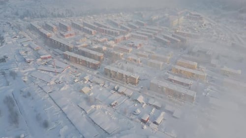 Snowcovered City Viewed From Above with Icy Roads and Snowy Landscape