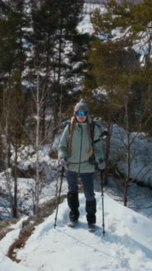 Woman Standing on Top of Mountain And Looking at Camera