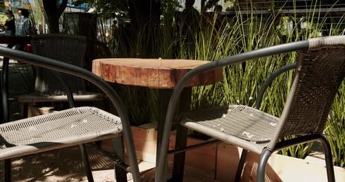 Wooden Tables with Black Modern Charis in Cafe on the Street