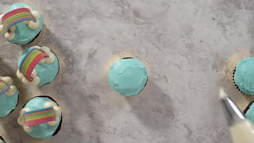 Time Lapse Flat Lay Decorating Chocolate Cupcakes with Buttercream Frosting and Rainbow Candy