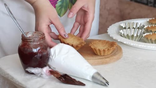 A Woman Makes A Cake Basket. Spreads Baked Cakes. Near The Filling Of Cream And Jam.