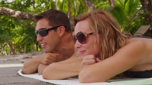 Couple Laying on Beach with Sunglasses. on Red Epic for High