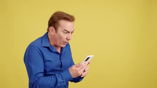 Man Reacting in Shock to Smartphone Content