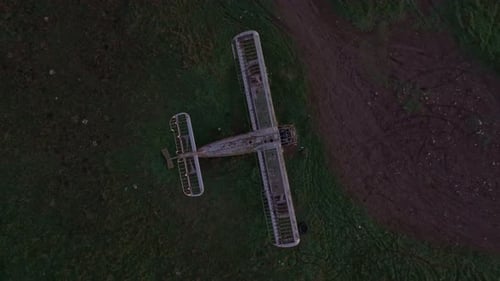 Aerial view of abandoned plane in green field at sunrise, Bulgaria.