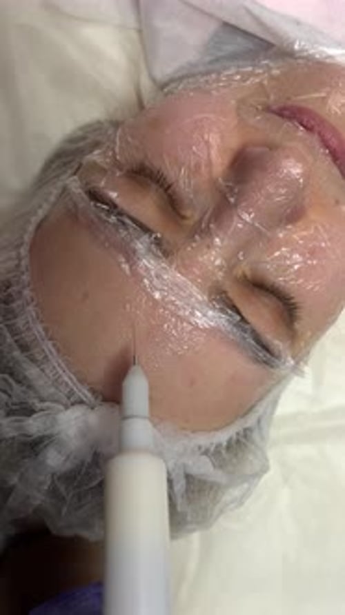 Woman Receiving Beauty Treatment on Face