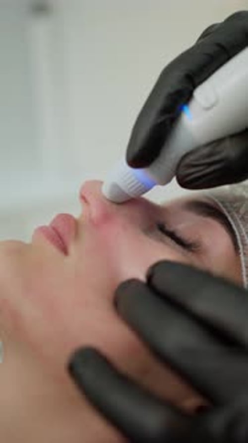 Woman Receiving Facial Cosmetic Procedure in Clinic