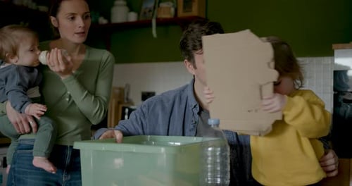 Family Recycles Plastic Bottles Together in the Kitchen