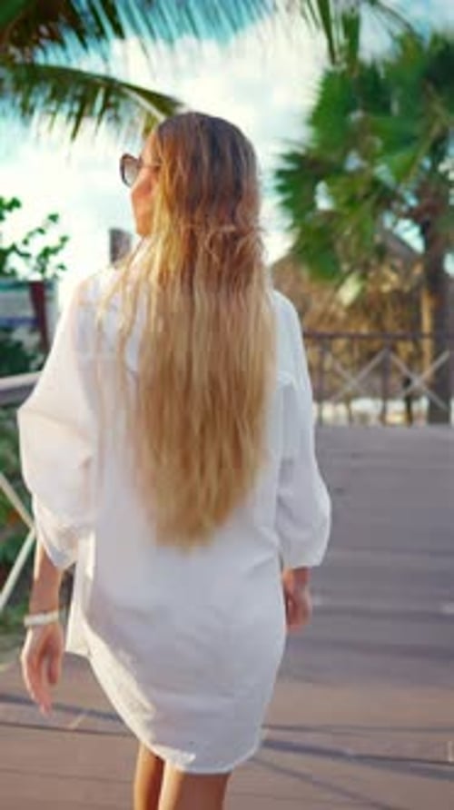 Carefree Woman Walking to Beach on Ocean Coast Following Shot Lady Strolling on Wooden Path in Hotel