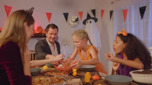 Family Celebrates Halloween with Pizza and Candy