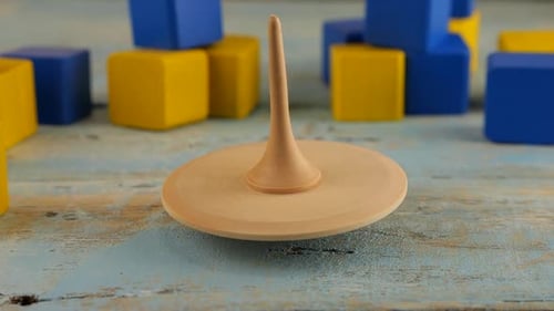 Close-up of Wooden Spinning Top Spinning on Wooden Surface
