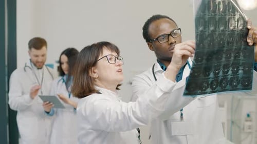 Doctors discussing medical x-ray in clinic