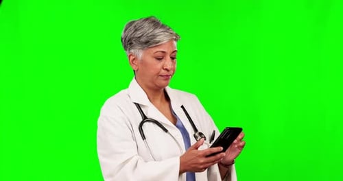 Online communication, female doctor on her smartphone and against a green screen for social
