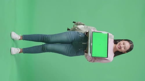 Full Body Of Asian Woman Student Showing Mock Up Laptop Green Screen On Green Screen Studio