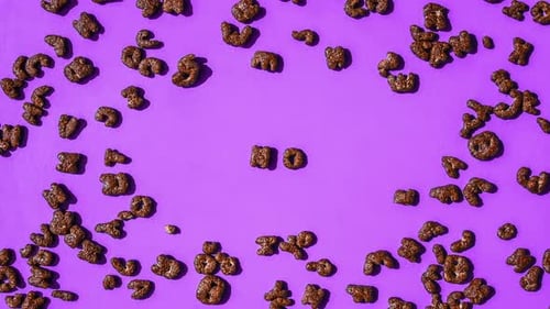 Alphabet Cereal Pieces Arranged on Purple Surface