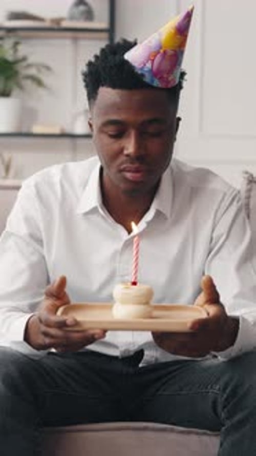 Lonely Sad Black Man Celebrating Birthday Alone at Home Portrait with Cake Vertical Video African