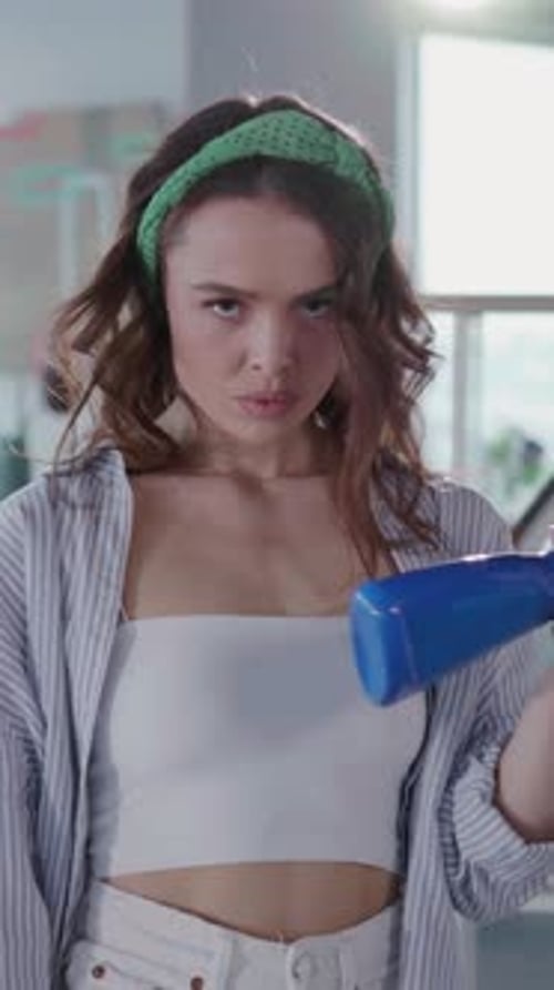 Daring Sexy Housewife Young Woman Spraying Water to Cool Down Looking Anrgy at Camera Exhausted with