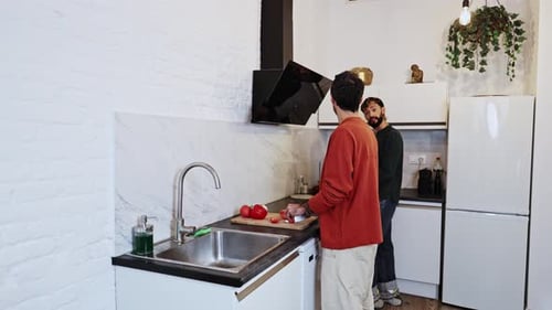 Two Friends Preparing Food Together in Kitchen