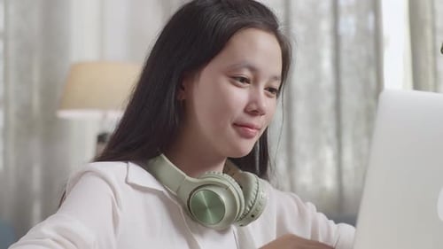 Young Woman Working on Laptop at Desk