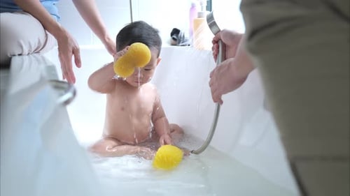 Child Bathing with Sponges and Shower Head