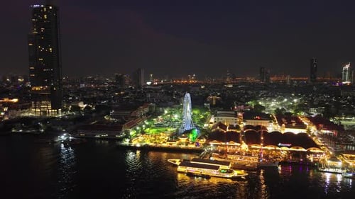Skyscrapers and Ferris Wheel in Bangkok City at Night