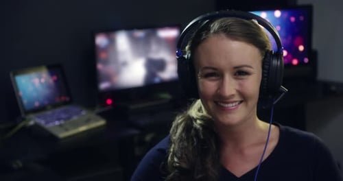 Woman Smiling Wearing Headphones in Computer Room