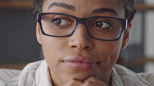 Professional Woman with Glasses in Workplace Setting