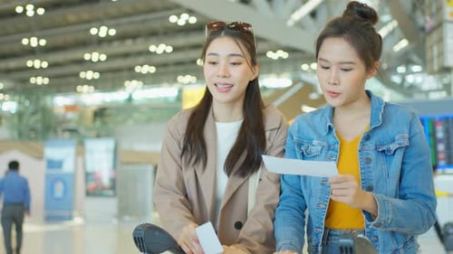 Asian young women passenger walk in airport terminal to boarding gate.