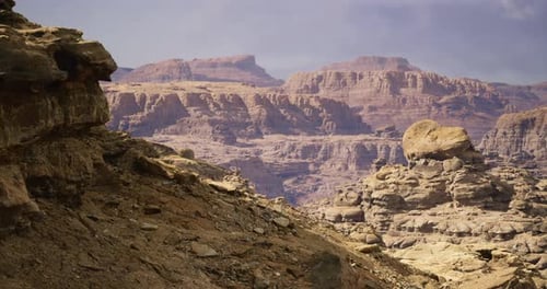 Desert Landscape with Rugged Hills and Unique Rock Formations in Daylight