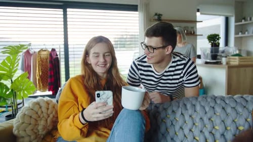 Friends Gather on Couch with Phone and Guitar