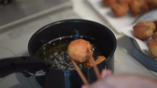 A woman making sata andagi