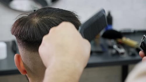 Person getting haircut in brightly lit room